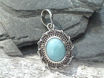 Larimar and sterling silver pendant measures around 1-1/8" tall with the bail by just over 5/8" wide at the max points and is light weight. Use a thin gauge chain with this pendant. The color and pattern on the stone will vary slightly from the sample photos with each pendant.