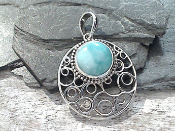 Larimar and sterling silver pendant measures around 1-1/2" tall with the bail by around 1-1/8" wide at the max points and is light to mid weight. Use a thin or medium gauge chain with this pendant. The color and pattern on the stone will vary slightly from the sample photos with each pendant.