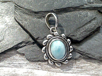 Larimar and sterling silver small pendant measures around around 1-1/8" tall with the bail by 5/8" wide at the max points and is light weight. Use a thin gauge chain with this pendant. The color and pattern on the stone will vary slightly from the sample photos with each pendant.