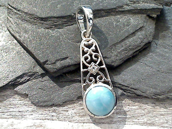 Larimar and sterling silver small pendant measures around around 1-3/8" tall with the bail by 3/8" wide at the max points and is light weight. There is a tiny CZ in the middle of the pendant. Use a thin gauge chain with this pendant. The color and pattern on the stone will vary slightly from the sample photos with each pendant.