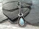 Larimar and sterling silver pendant measures around around 1-3/4" tall with the bail by 5/8" wide at the max points and is light weight. Use a thin gauge chain with this pendant. The color and pattern on the stone will vary slightly from the sample photos with each pendant.